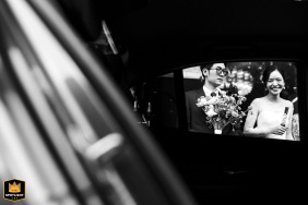   A joyful ride about to take place at The Athenee Hotel Bangkok, where the couple enjoys a lighthearted moment together, adding energy and excitement to their wedding day.